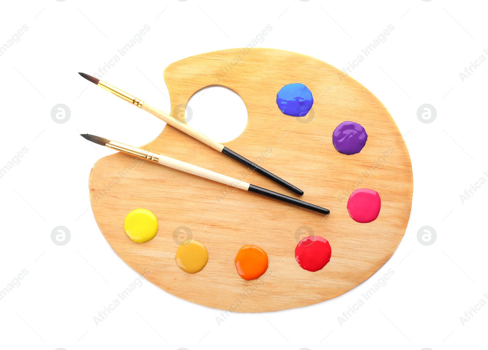 Photo of Palette with paints and brushes on white background, top view