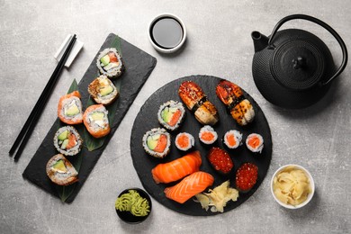 Photo of Flat lay composition with delicious sushi rolls on light grey table