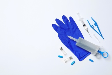 Photo of Flat lay composition with medical glove on white background. Space for text