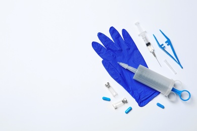 Flat lay composition with medical glove on white background. Space for text