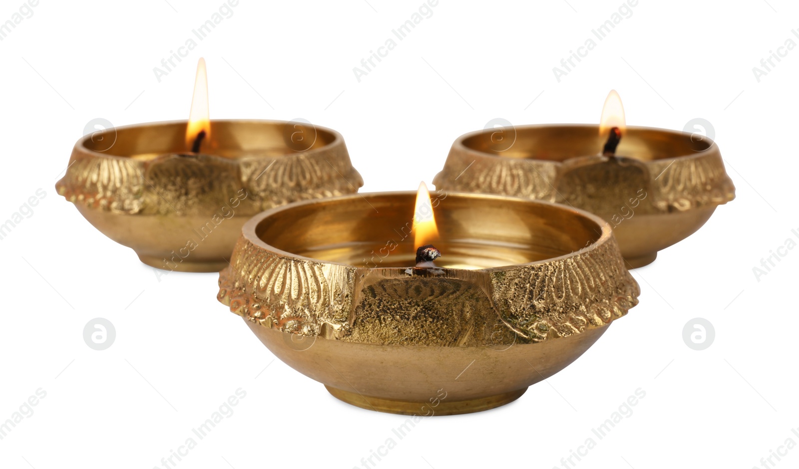 Photo of Lit diya lamps on white background. Diwali celebration