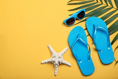 Flat lay composition with beach objects on color background