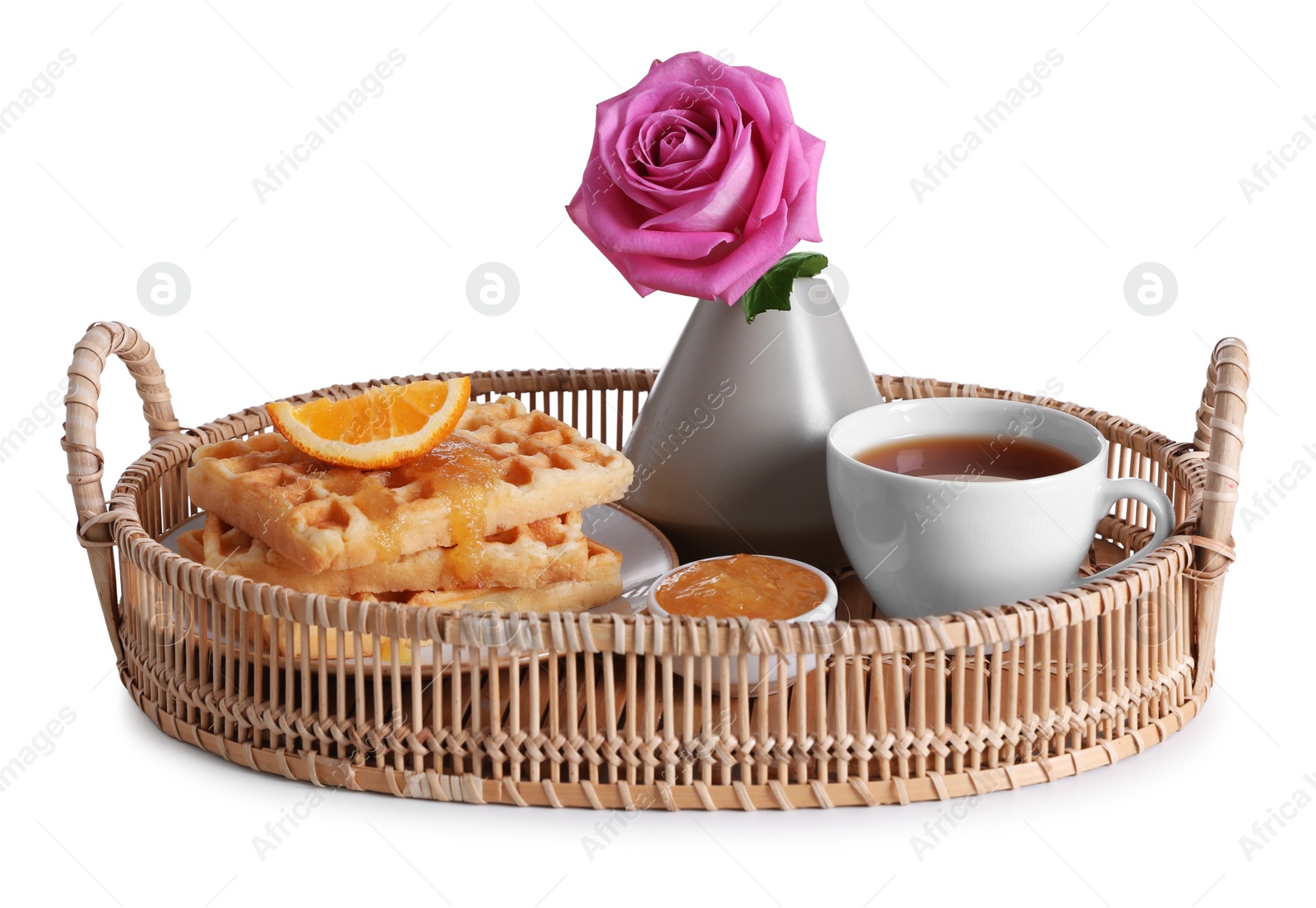 Photo of Wicker tray with delicious breakfast and beautiful flower on white background