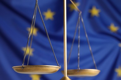 Photo of Scales of justice against European Union flag, closeup