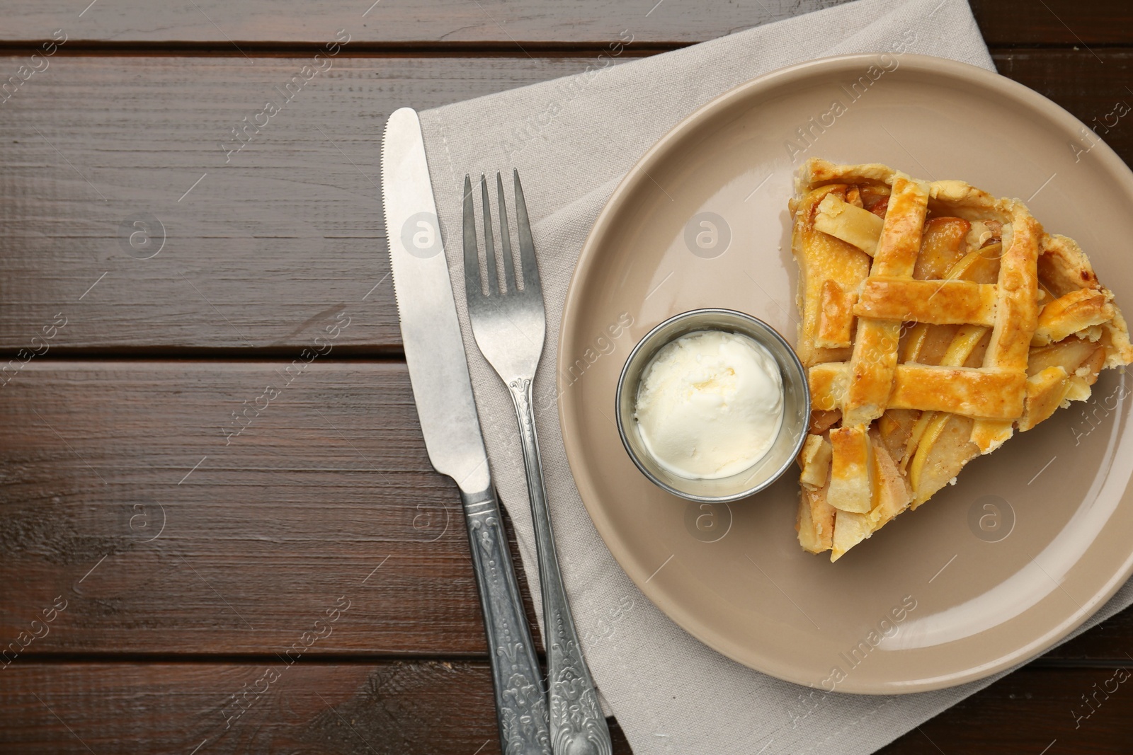 Photo of Piece of tasty homemade quince pie served on wooden table, flat lay. Space for text