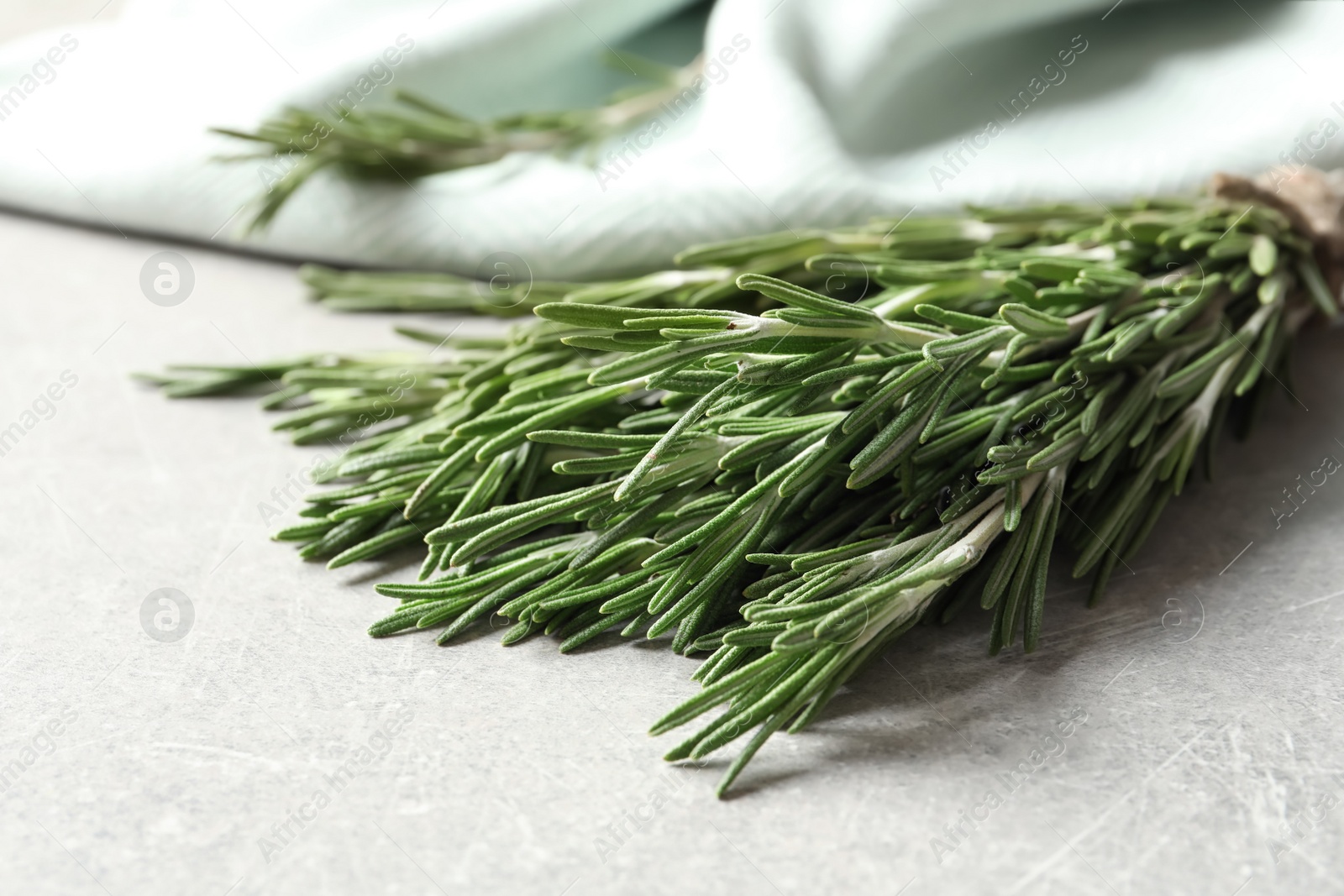 Photo of Fresh rosemary twigs on table, closeup