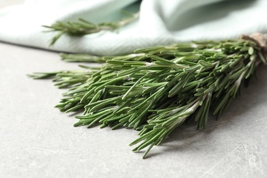 Fresh rosemary twigs on table, closeup