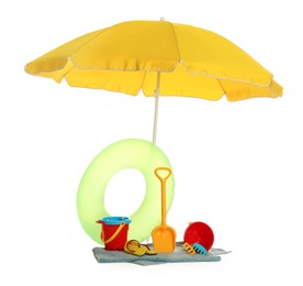 Photo of Beach umbrella, inflatable ring, towel and child's sand toys on white background