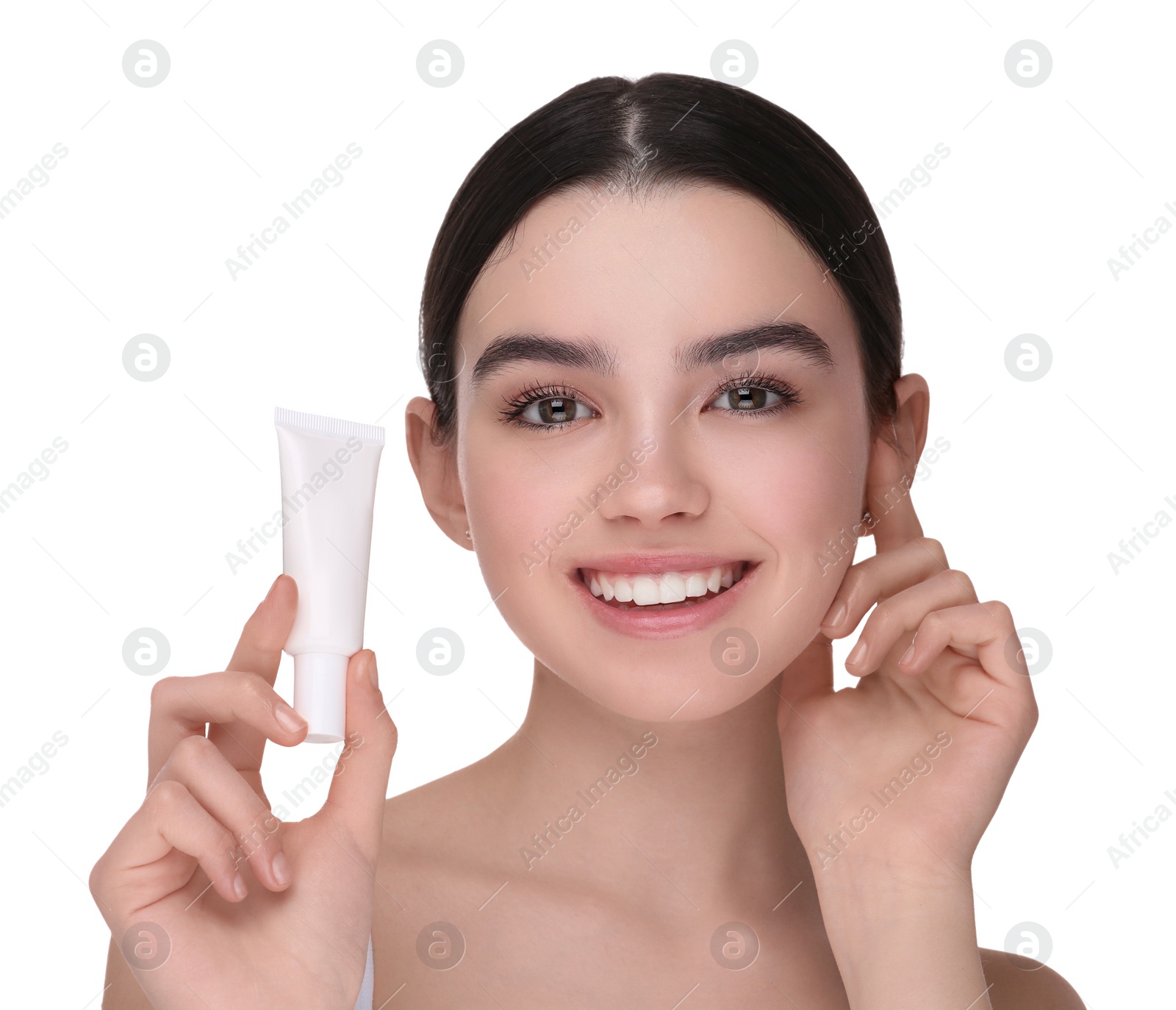 Photo of Teenage girl holding tube of foundation on white background