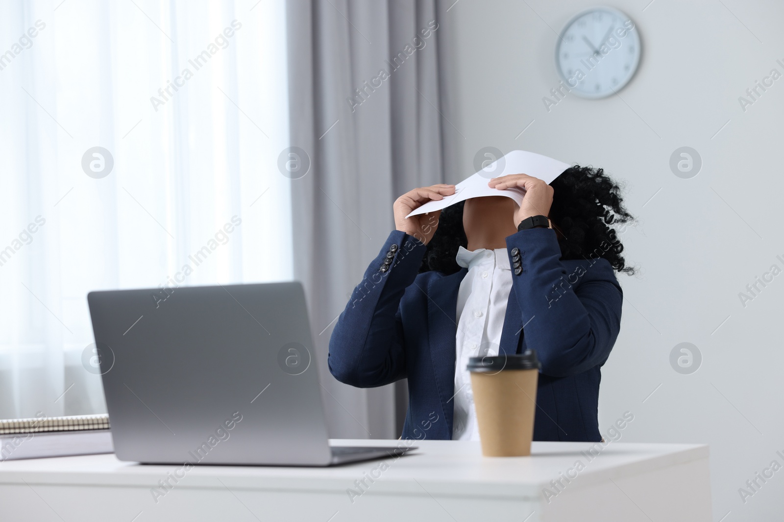 Photo of Deadline concept. Woman covering face with document in office