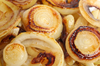 Photo of Tasty fried onion as background, closeup view
