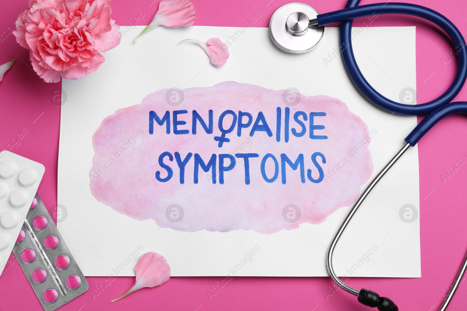 Photo of Sheet of paper with words Menopause Symptoms, stethoscope, carnation flower and pills on pink background, flat lay