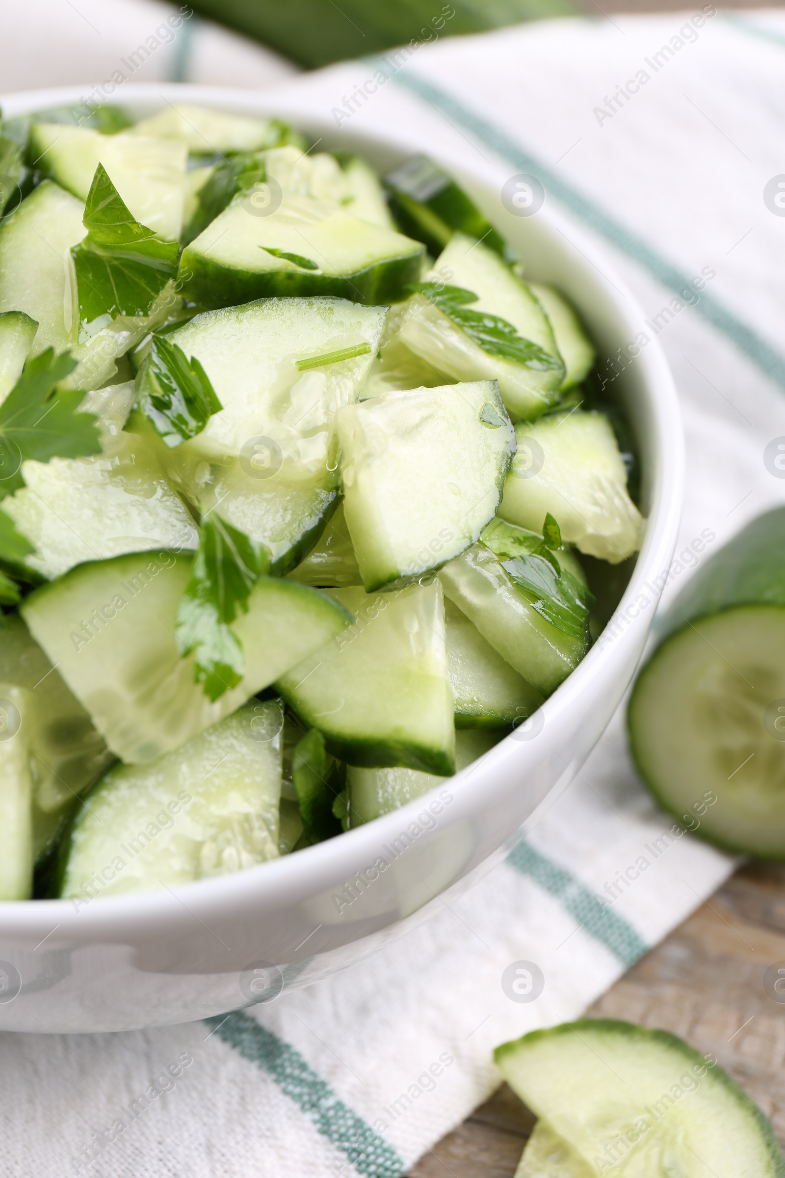 Photo of Delicious cucumber salad in bowl on table, closeup