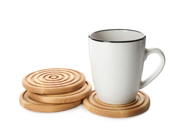 Mug and stylish wooden coasters on white background