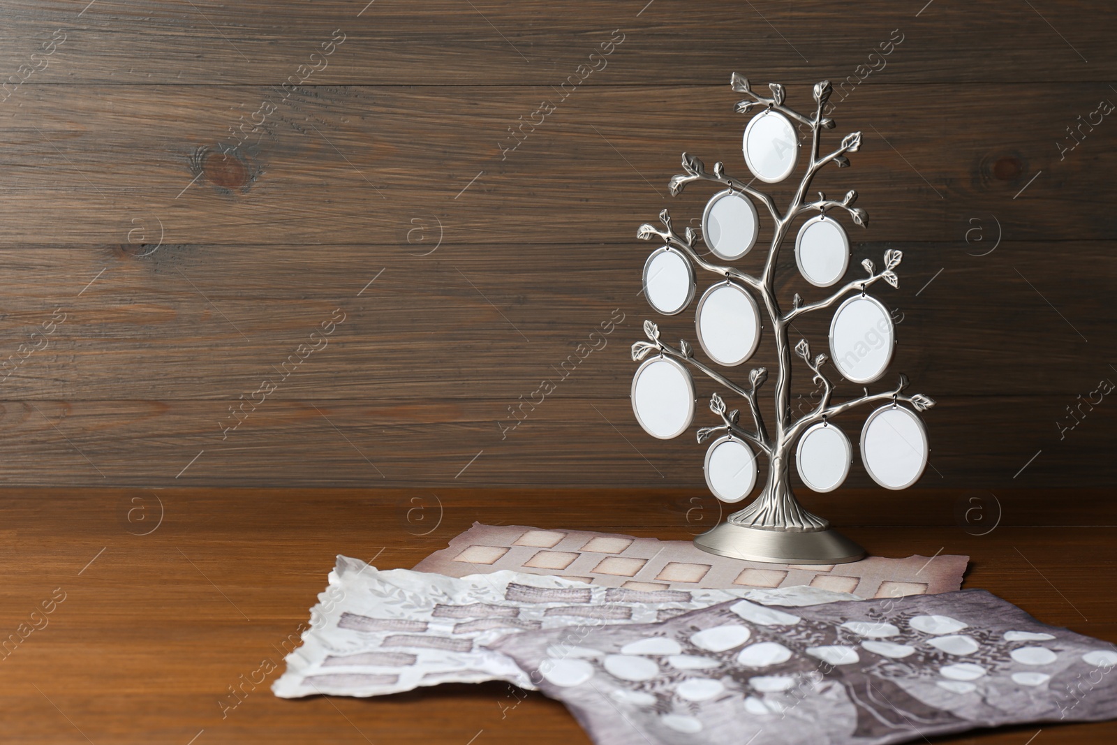 Photo of Papers and photo frame with family tree templates on wooden table. Space for text