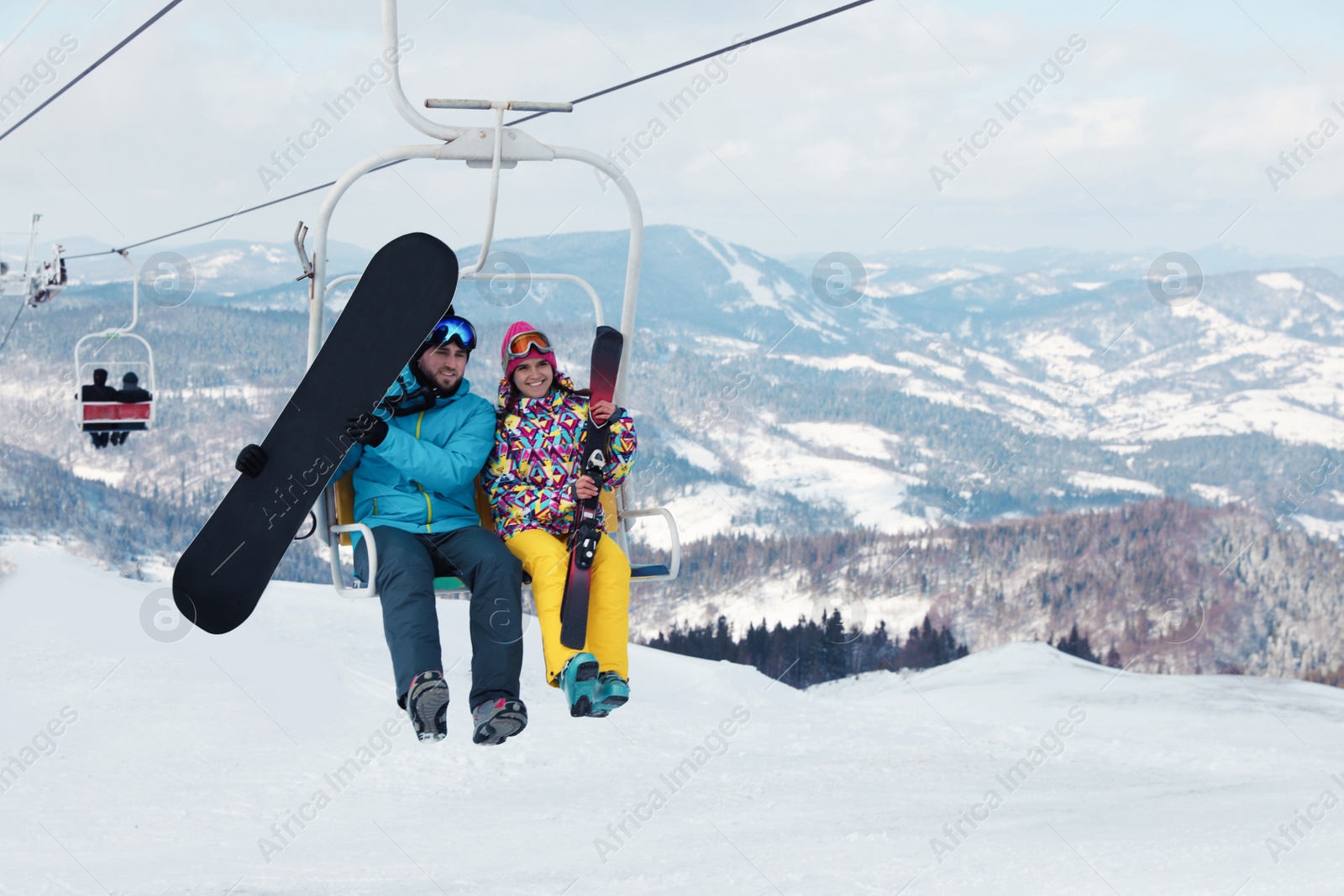 Photo of People using chairlift at mountain ski resort. Winter vacation