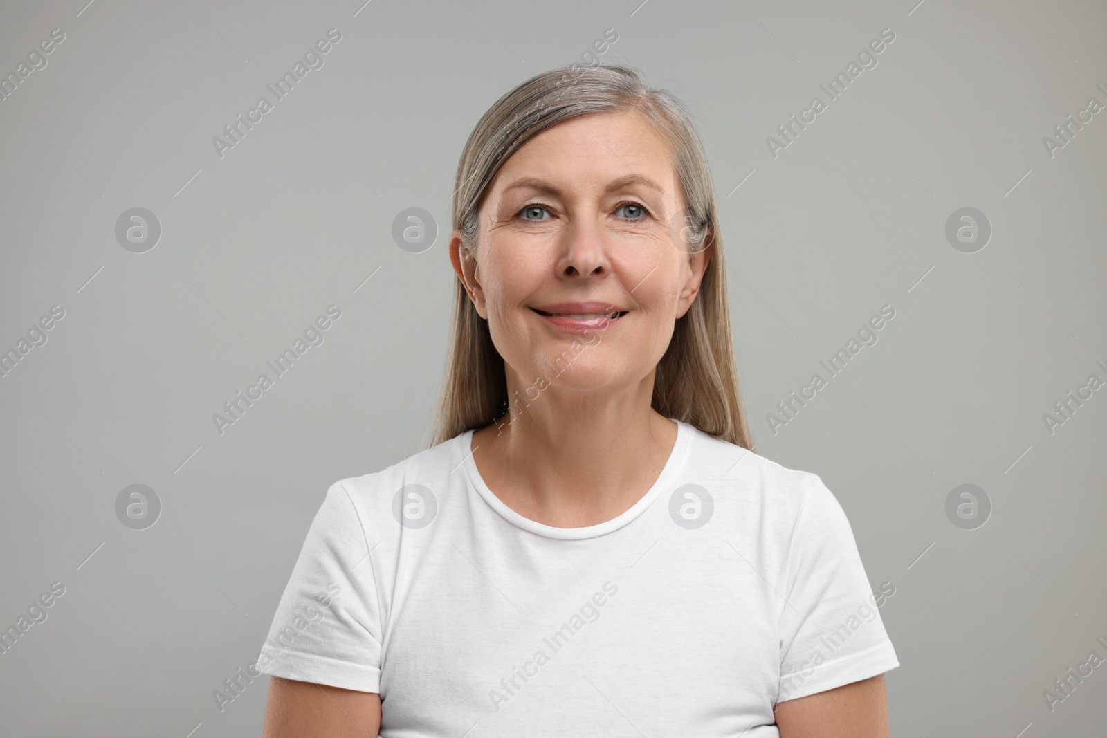 Photo of Beautiful woman with healthy skin on grey background