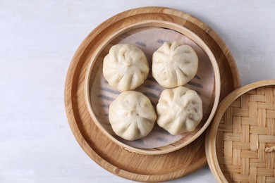 Delicious bao buns (baozi) on light table, top view