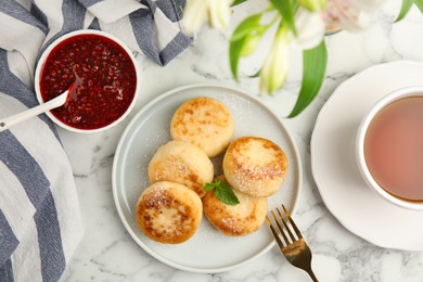 Photo of Delicious cottage cheese pancakes with mint and icing sugar on white marble table, flat lay