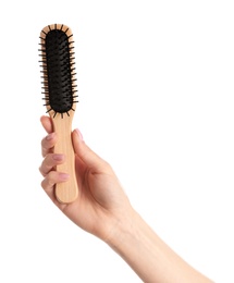 Photo of Woman holding wooden hair brush against white background, closeup