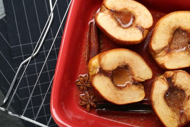 Photo of Tasty baked quinces with anise and honey in dish on table, top view