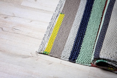 Colorful striped carpet on wooden floor