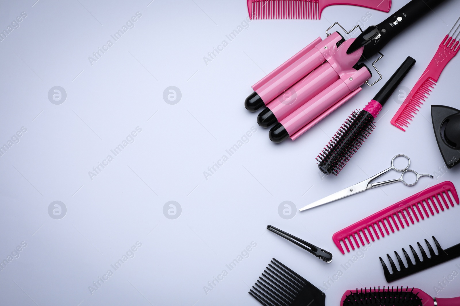 Photo of Flat lay composition with modern hair triple curling iron on white background, space for text