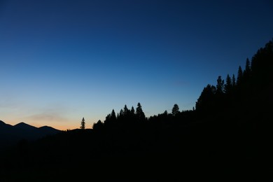 Photo of Silhouette of mountains against beautiful sky at night