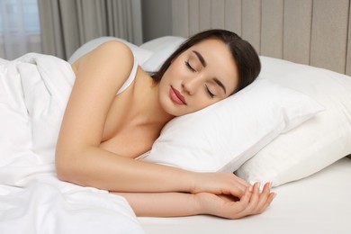 Beautiful young woman sleeping in soft bed
