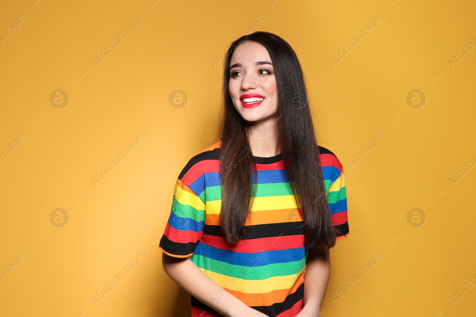 Photo of Portrait of beautiful young woman on colorful background