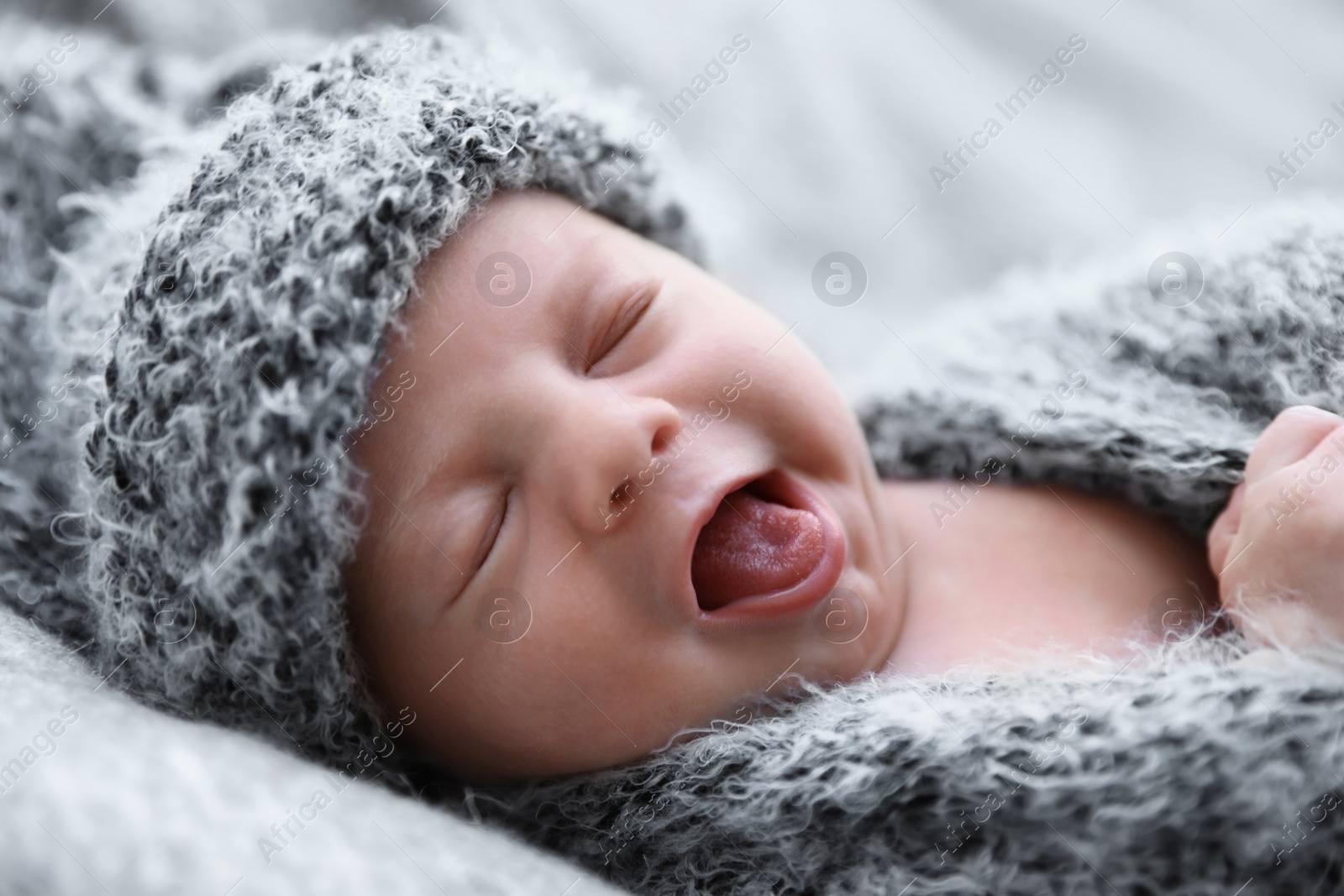Photo of Cute newborn baby lying on blanket, closeup