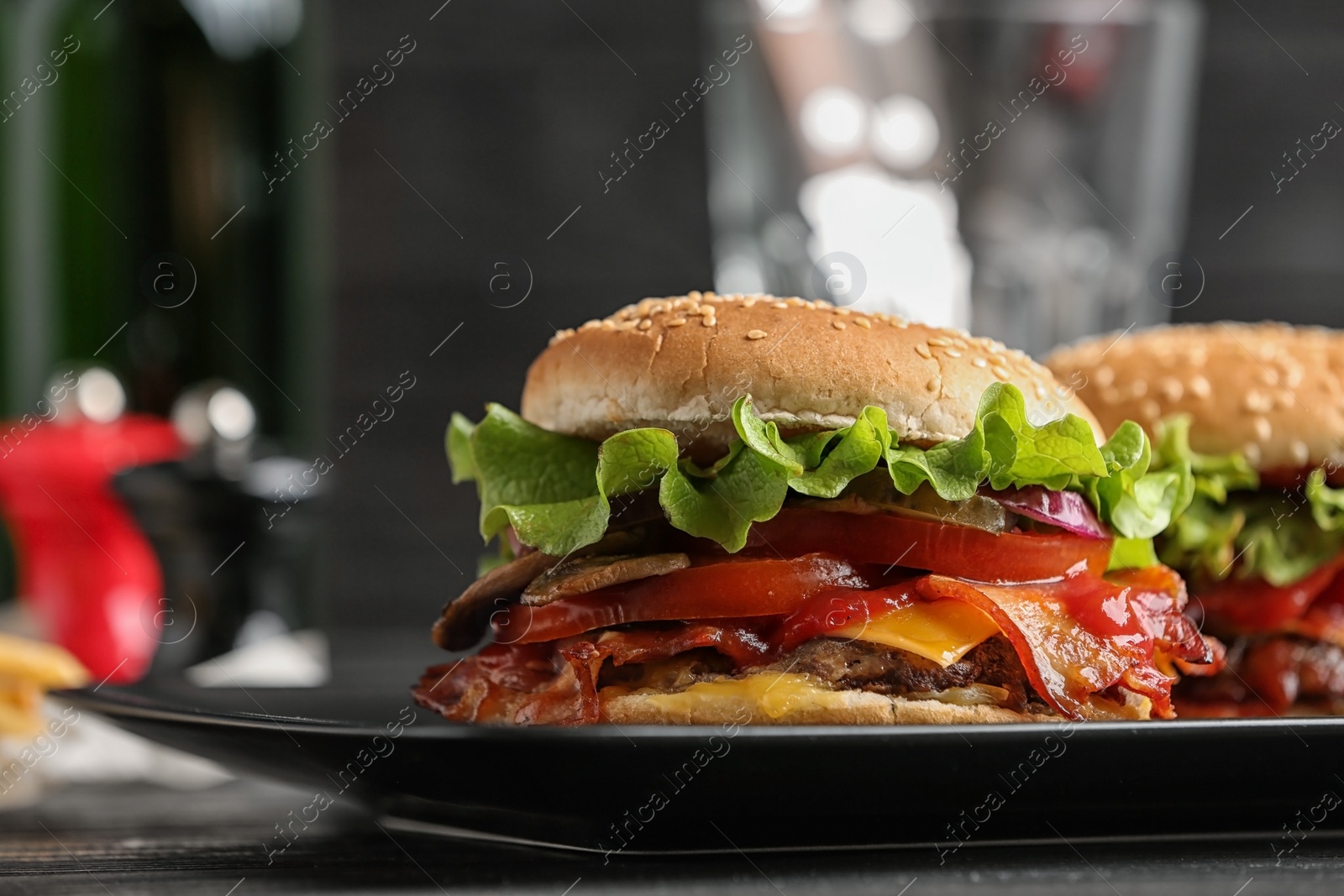 Photo of Plate with tasty burgers on table. Space for text