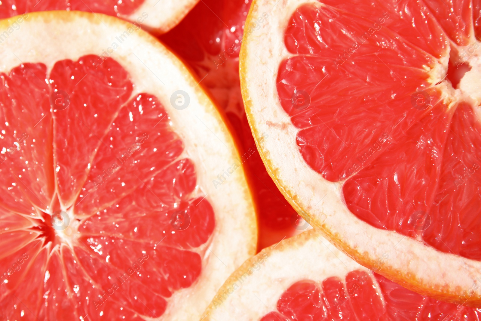 Photo of Many slices of fresh ripe grapefruits as background, closeup