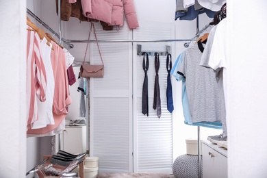 Modern dressing room with different stylish clothes and accessories