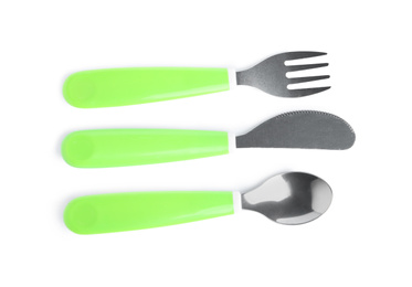 Cutlery with plastic handles isolated on white, top view. Serving baby food