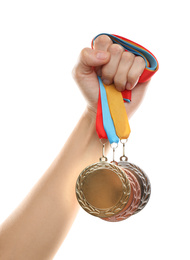 Woman holding medals on white background, closeup. Space for design