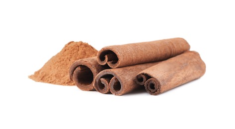 Photo of Dry aromatic cinnamon sticks and powder isolated on white