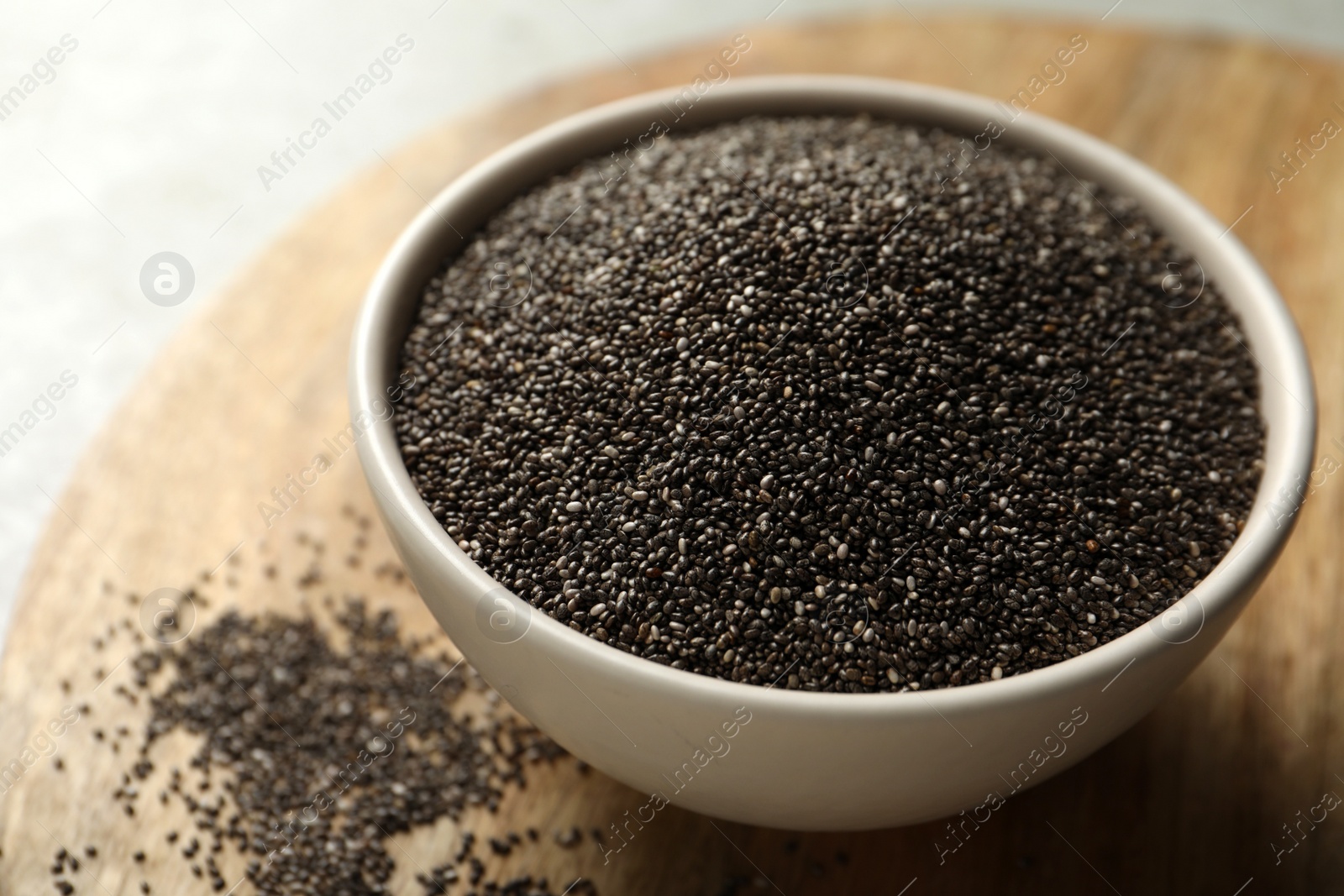Photo of Chia seeds in bowl on table, closeup
