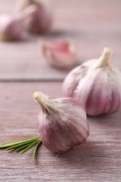 Bulbs of fresh garlic on wooden table, selective focus