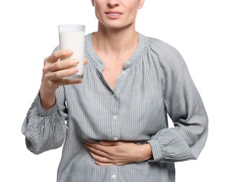 Woman with glass of milk suffering from lactose intolerance on white background, closeup