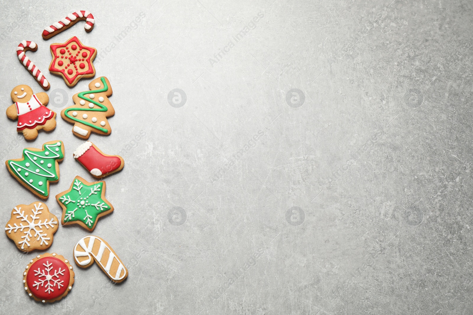 Photo of Flat lay composition with tasty homemade Christmas cookies on grey table, space for text