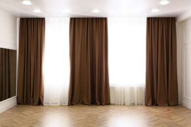 Photo of Windows with elegant curtains in modern room