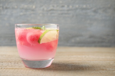 Tasty refreshing watermelon drink on wooden table. Space for text