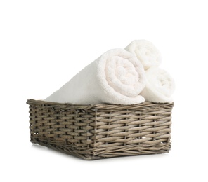 Rolled soft terry towels in wicker basket on white background