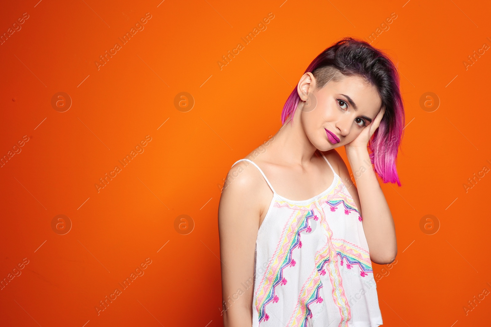 Photo of Young woman with trendy hairstyle against color background