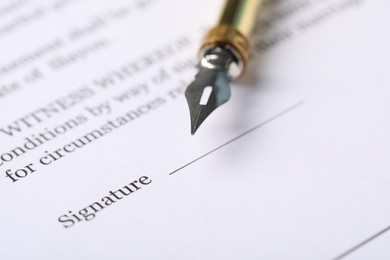 Photo of Marriage contract and pen on table, closeup