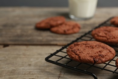 Delicious chocolate chip cookies on wooden table, closeup. Space for text