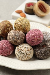 Photo of Different delicious vegan candy balls on table, closeup