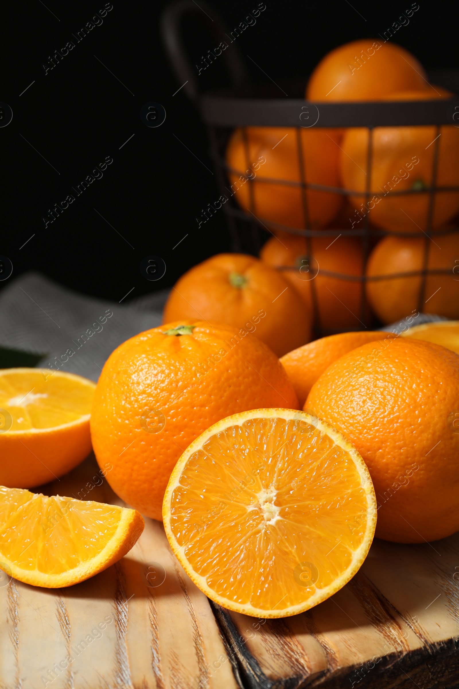 Photo of Wooden board with ripe oranges on table. Space for text