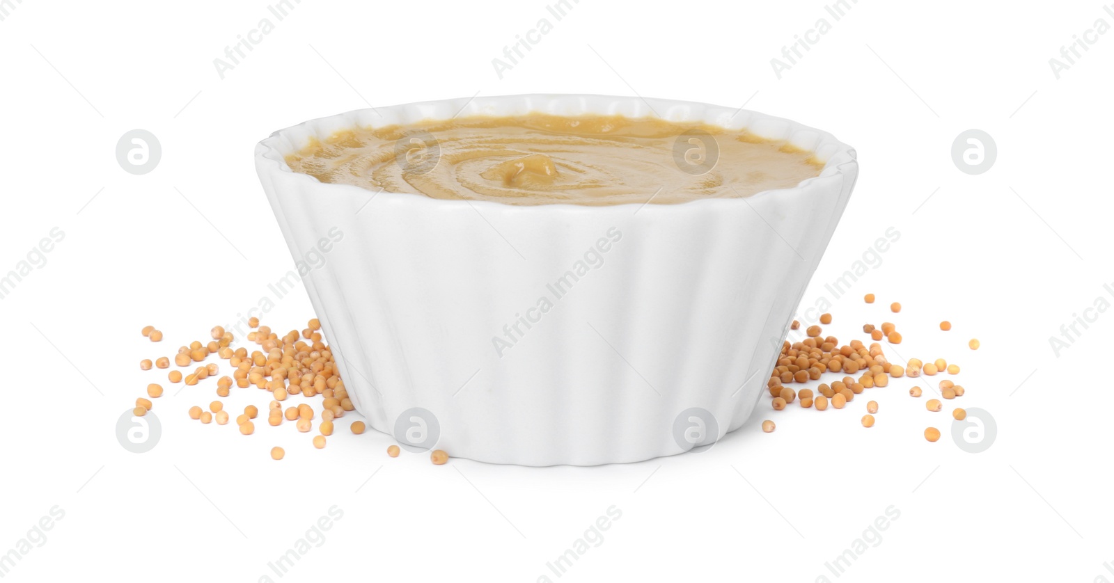 Photo of Fresh tasty mustard sauce in bowl and dry seeds isolated on white